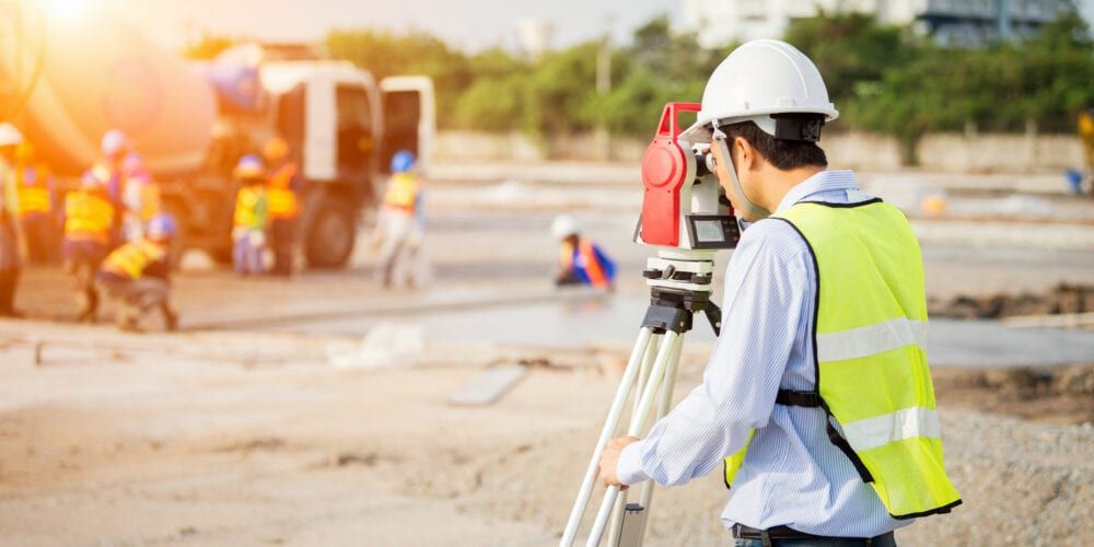 Spatial science graduate using surveying tools