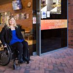 Person in wheelchair at disability services building