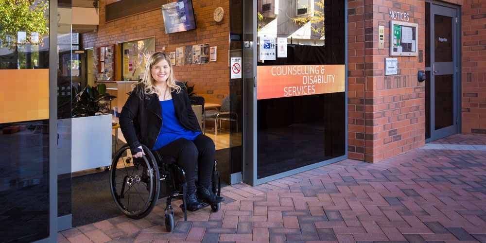 Person in wheelchair at disability services building