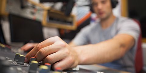 Radio host moderating touching switch in studio at college