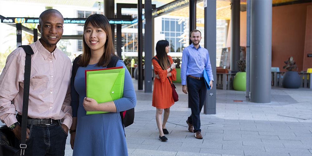 A group of students walking through the Curtin Business School