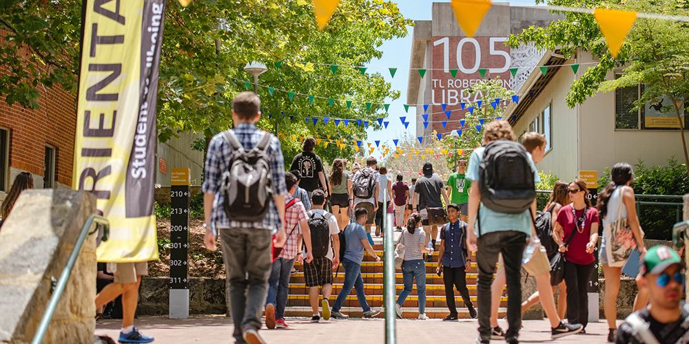 A group of students walking around the Curtin grounds - play video