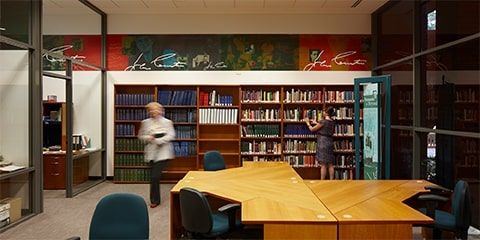 Two females looking at books within the John Curtin Prime Ministerial Library