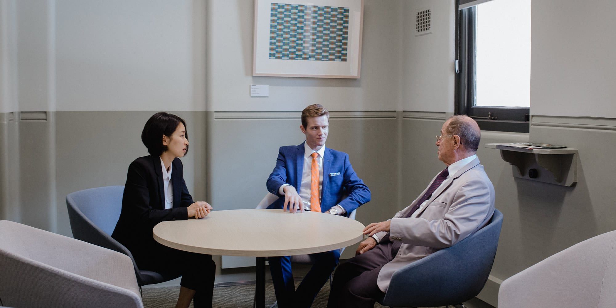 Two students meeting with a practising lawyer at the Curtin Law clinic