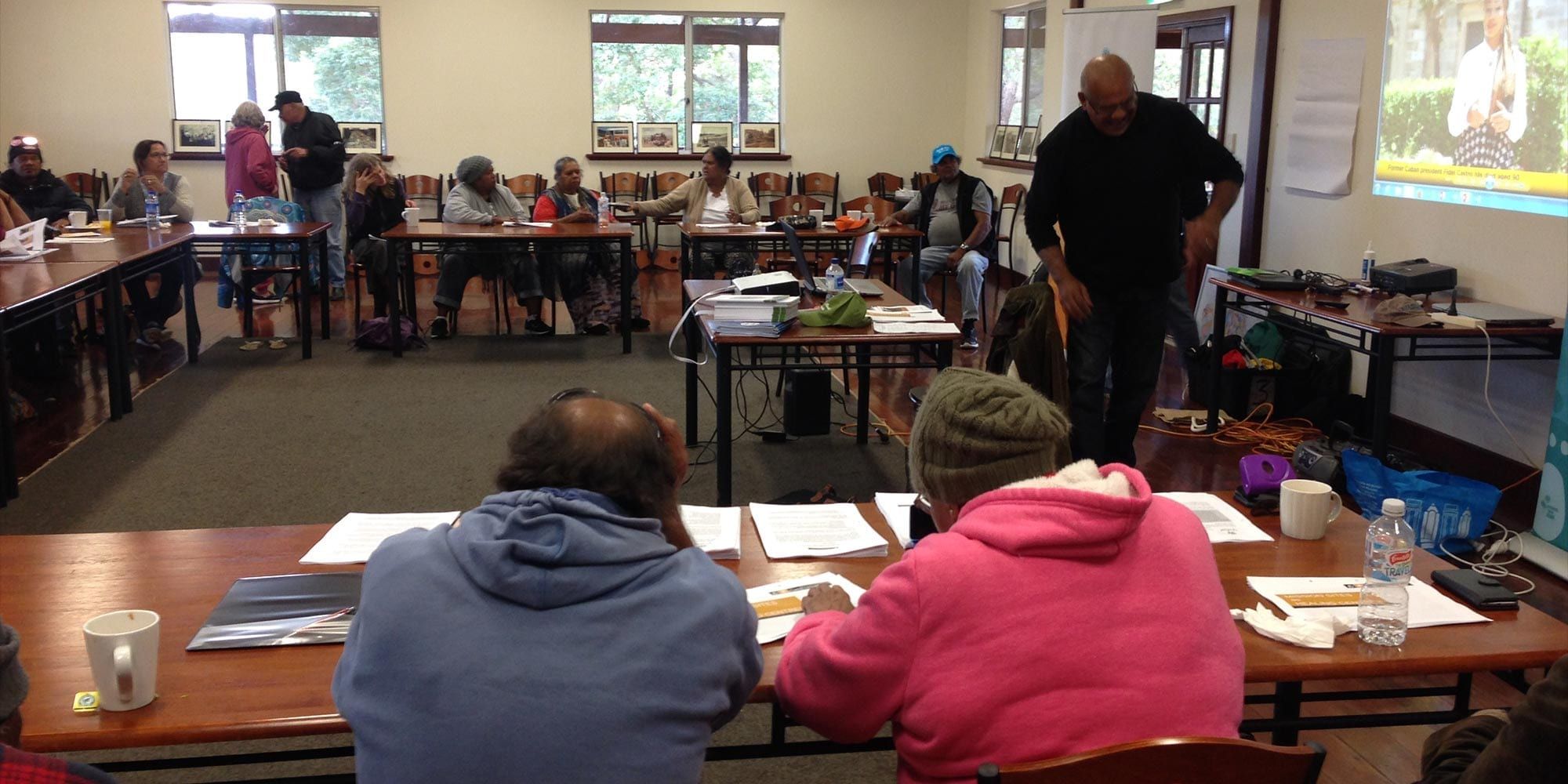 Group of people sitting in a meeting for the healing centres for the stolen generations survivors