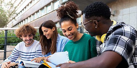 Group of mixed high school students looking at a paper