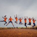 A group of students attending John Curtin Weekend jumping in the air