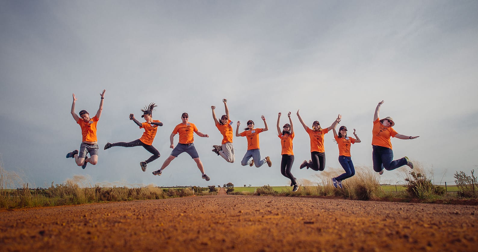 A group of students attending John Curtin Weekend jumping in the air