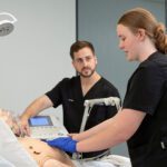 Two student nurses at Curtin working on a model patient