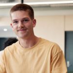 Student in the library smiling