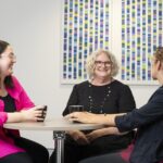 Three female social workers chatting