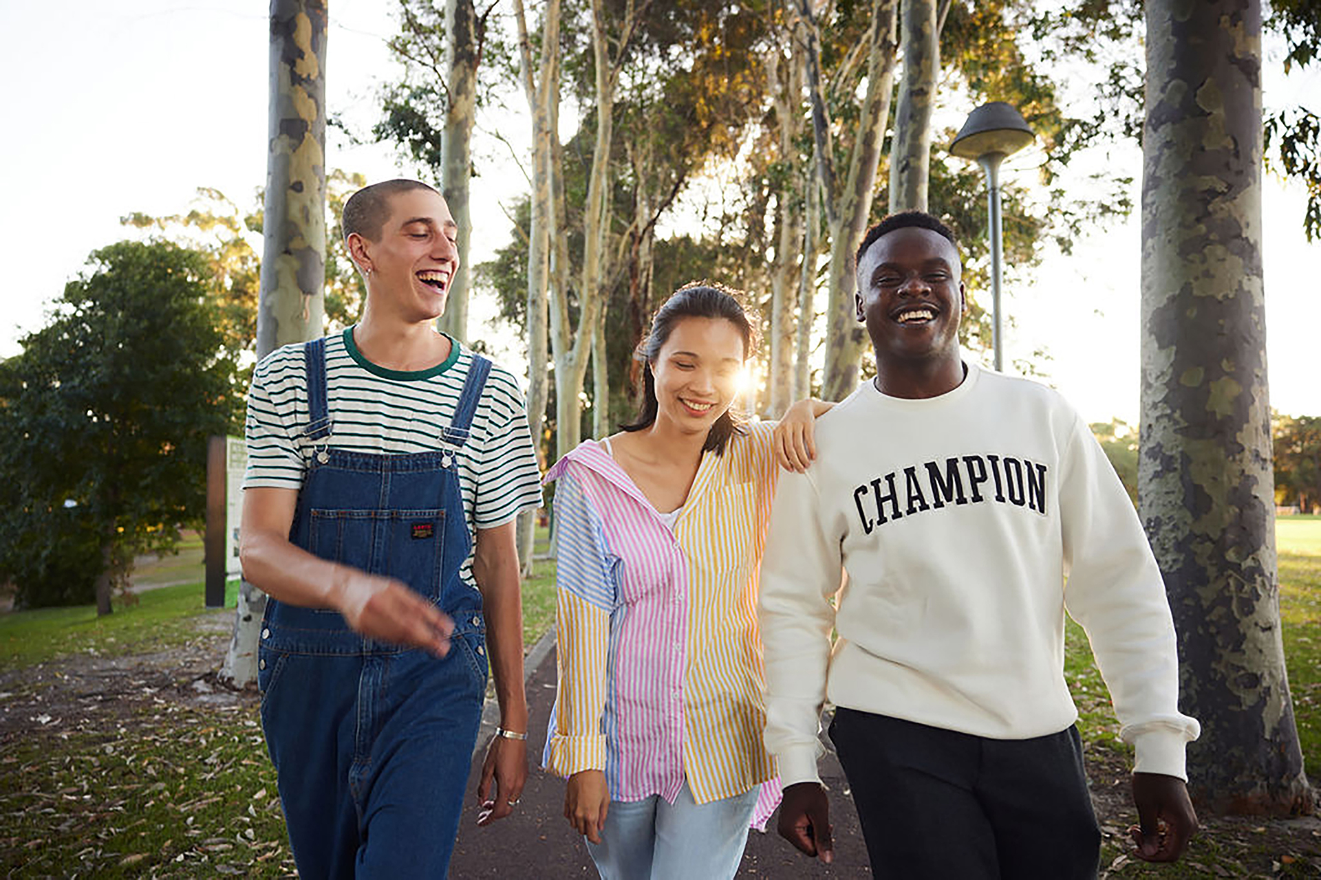 Three students walk on a Curtin University pathway