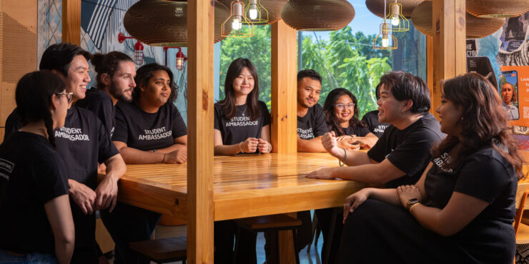 A group of student ambassadors around a table.