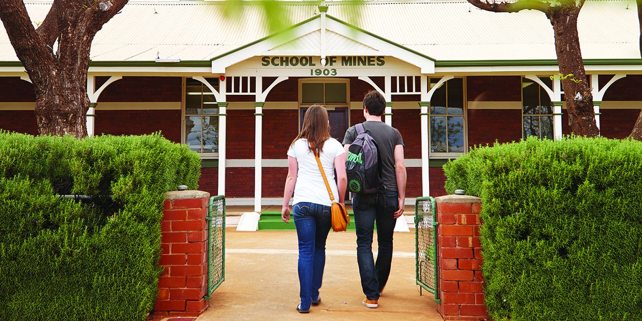 A male and female student walking into Curtin Kalgoorlie campus