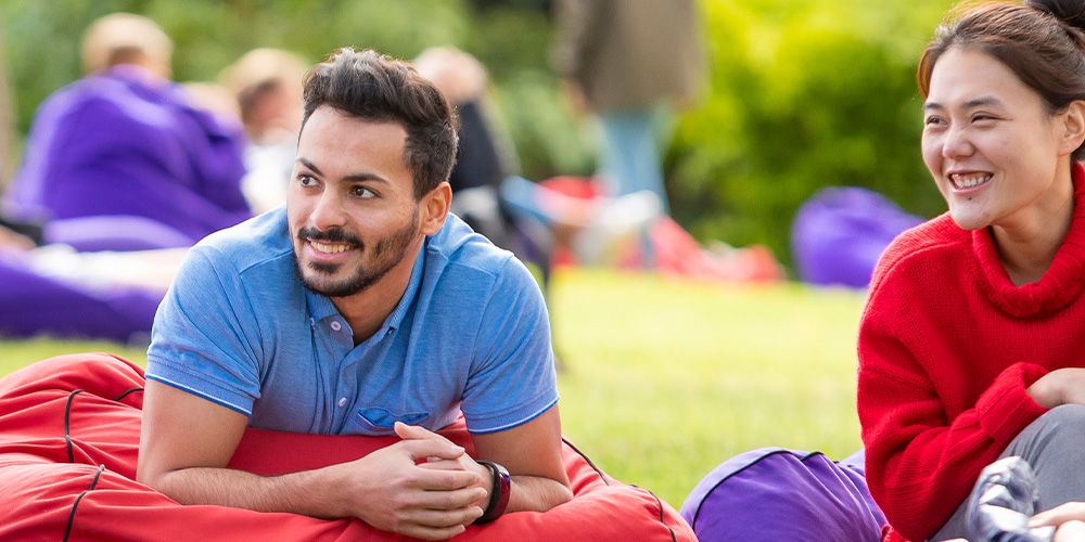 Two students sitting on bean bags, smiling - play video