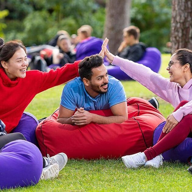 International students on beanbags outside