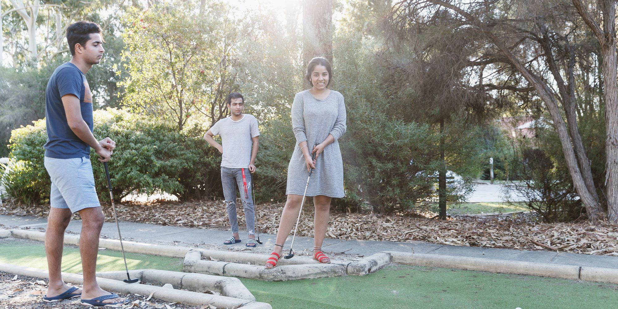 Students playing mini golf outside accommodation