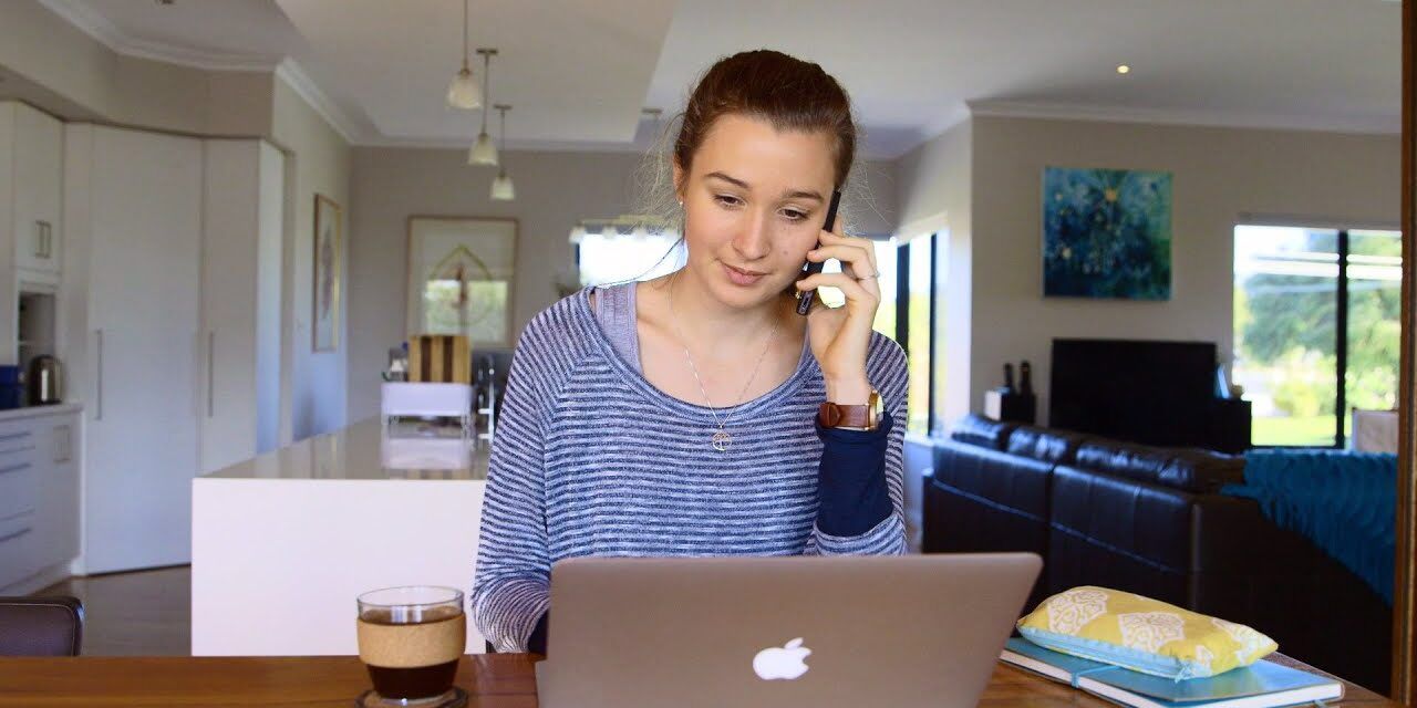 Student working on a laptop - play video