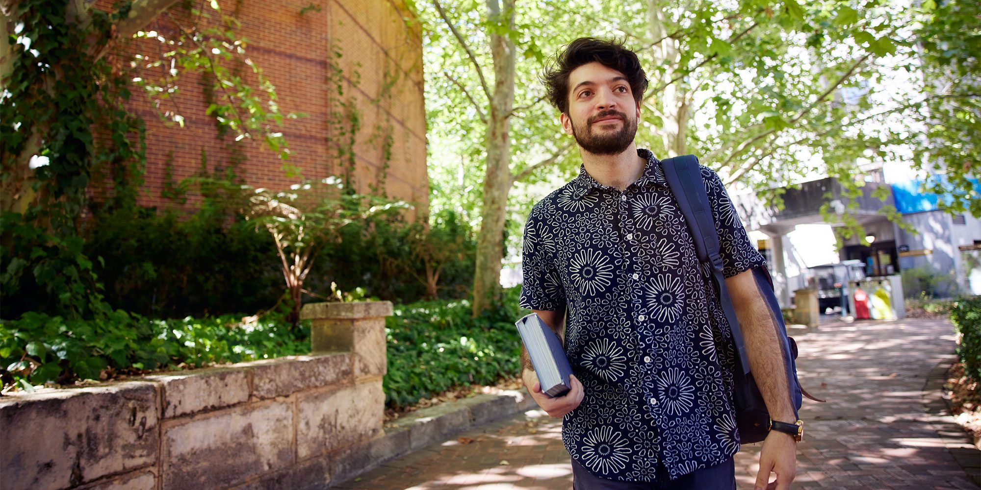 Student walking down a pathway outdoors