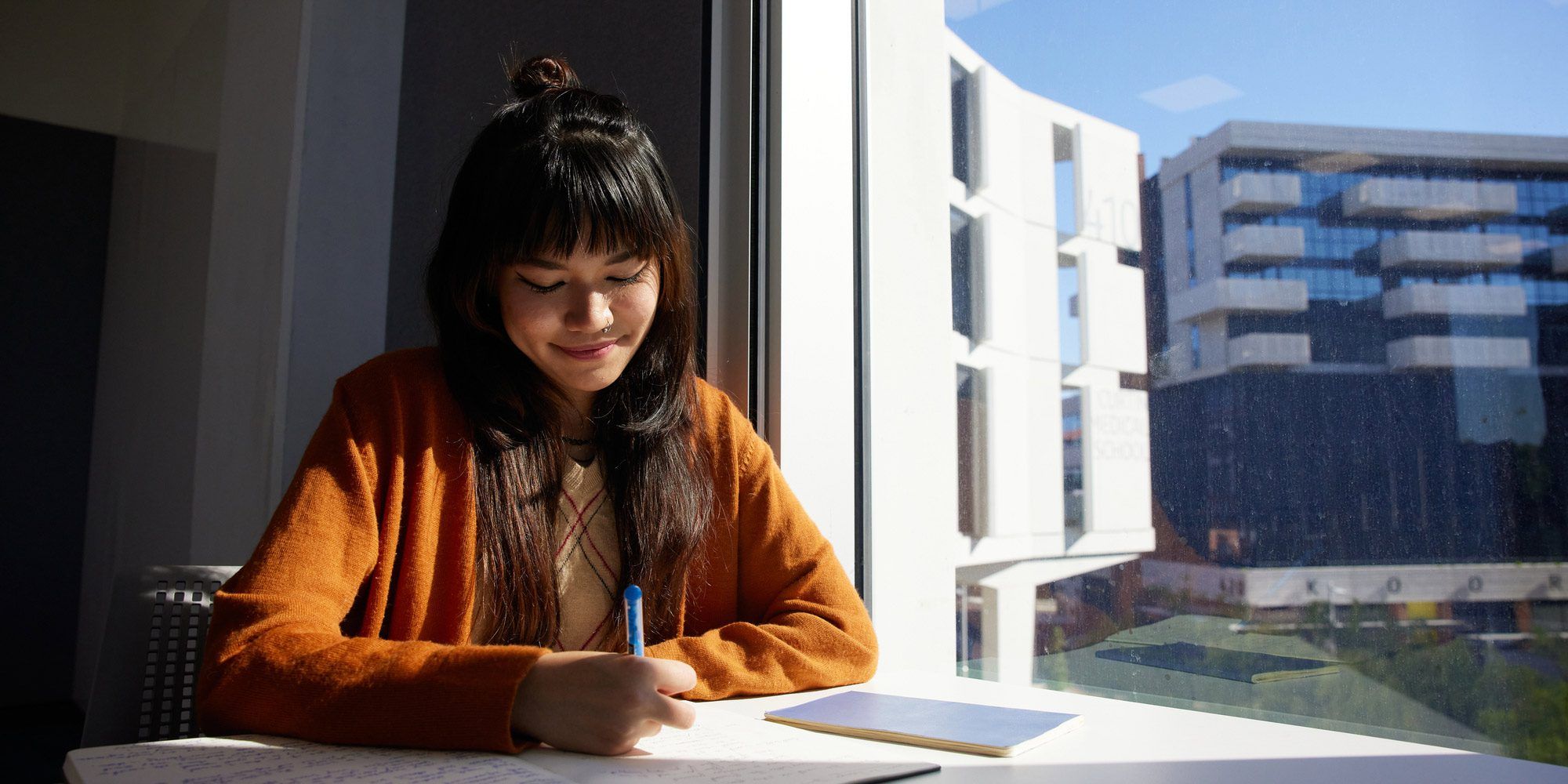 Student writing in notebook