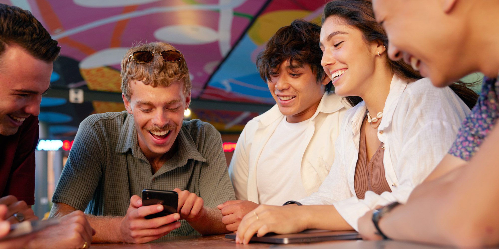 A group of students looking at a mobile