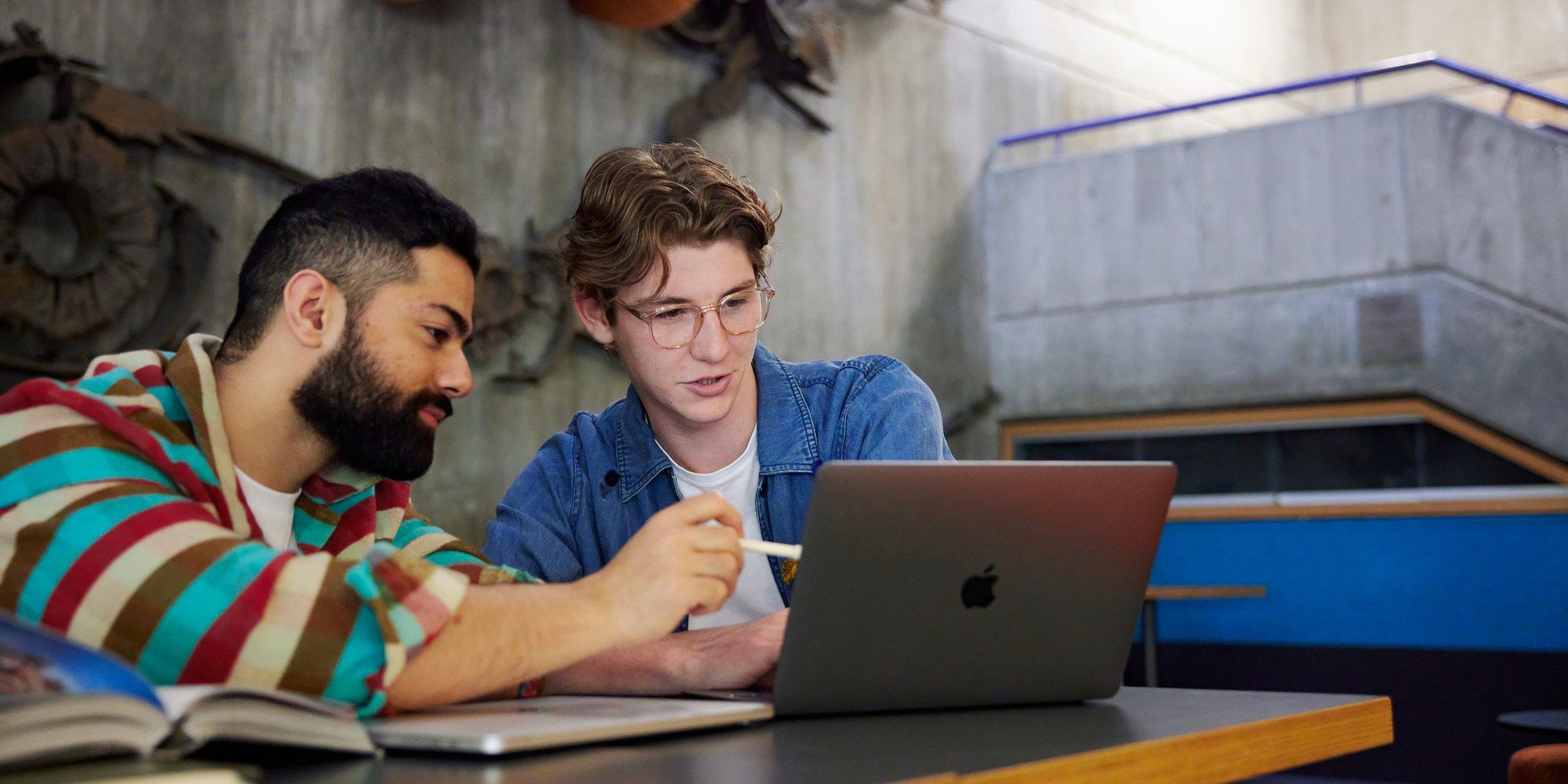 Two students looking at a laptop