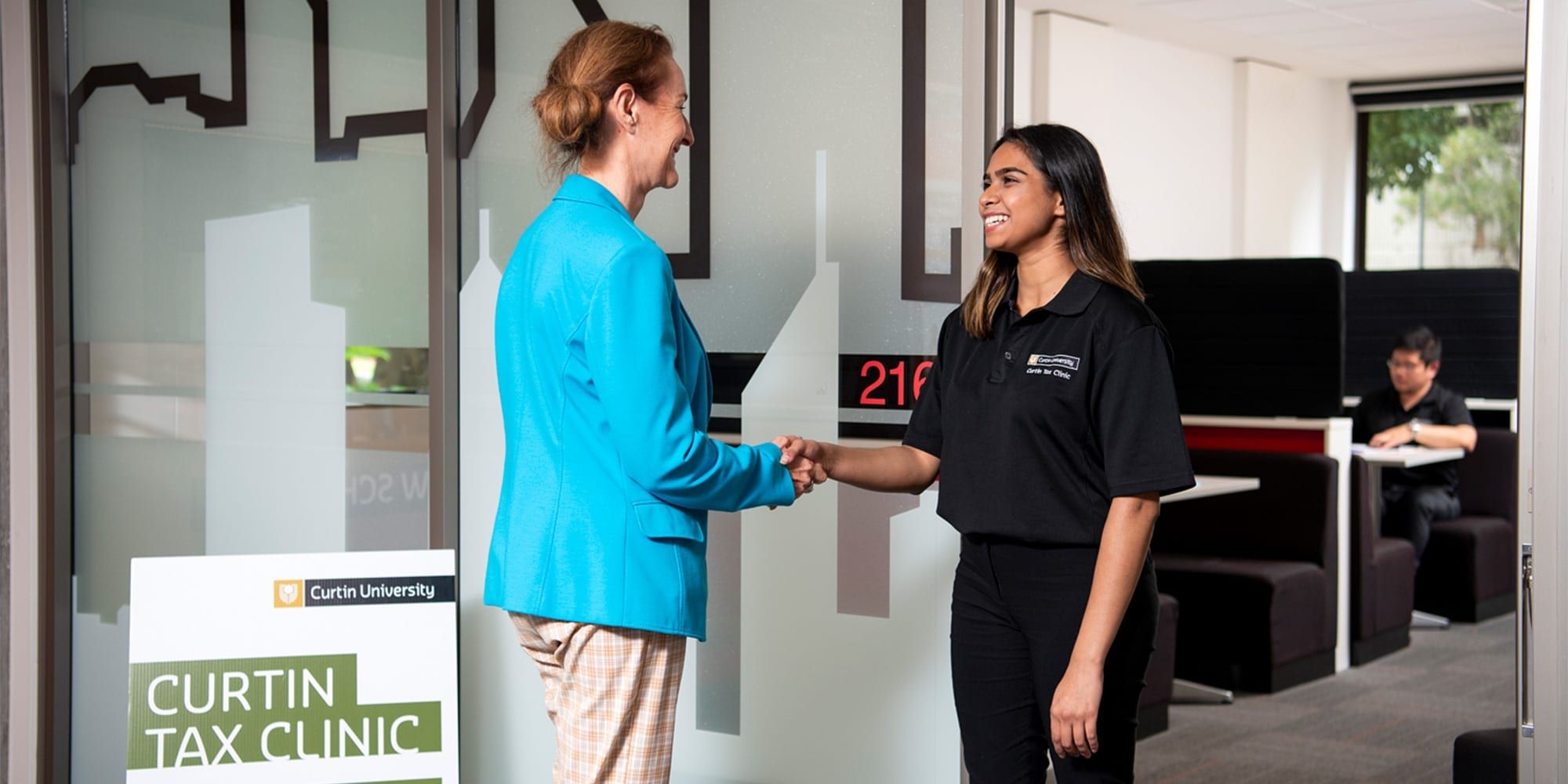 Curtin student shaking hands with a client at the Curtin Tax Clinic