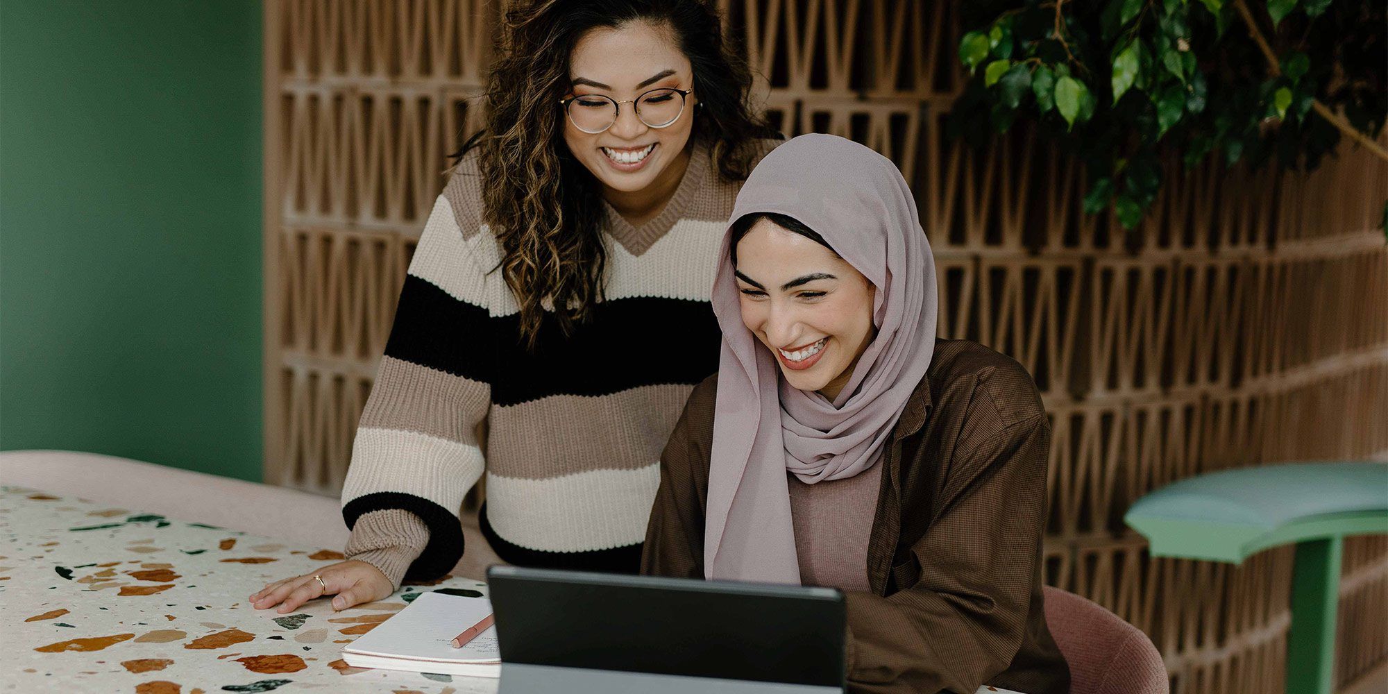 Two students looking at a tablet computer