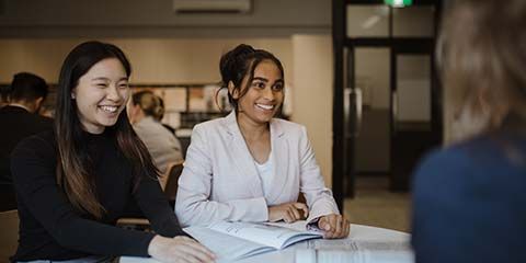 Two female law students in a communal study space