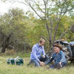 doctor treating an old farmer sitting next to a tractor