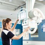 Female student with a radiology machine