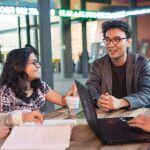 Two people, male and female, sitting at a cafe at Curtin Campus.