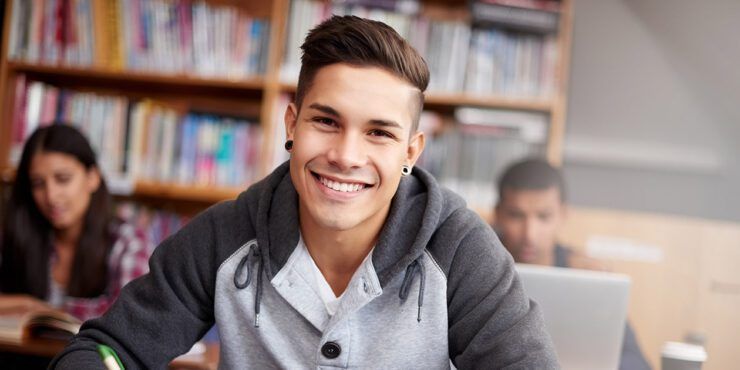 young male student in a library