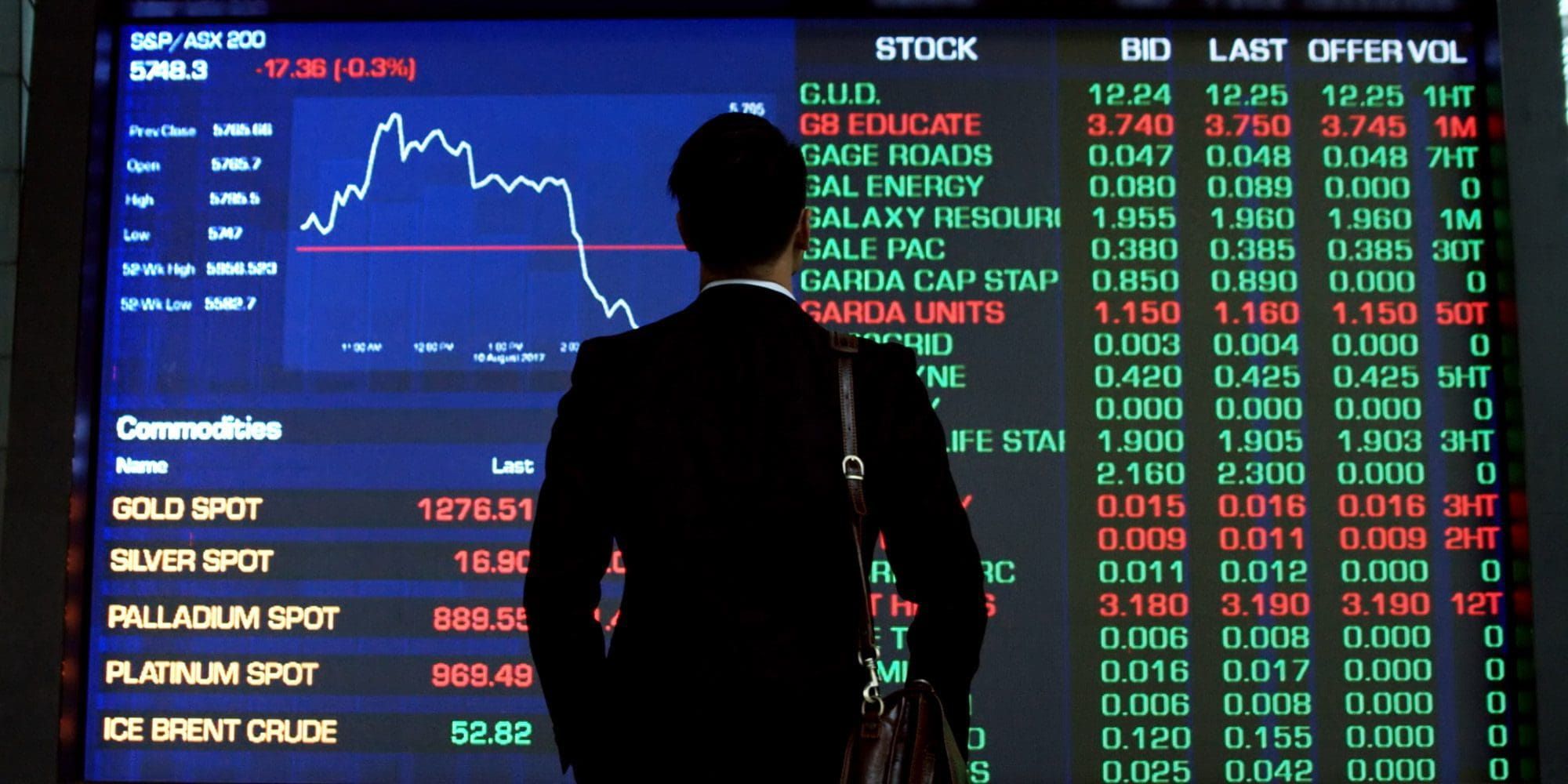 Man looking at ASX stock listing