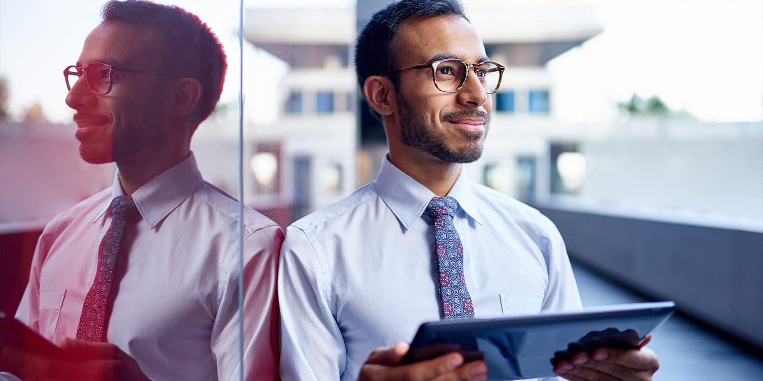 Man in suit using tablet computer