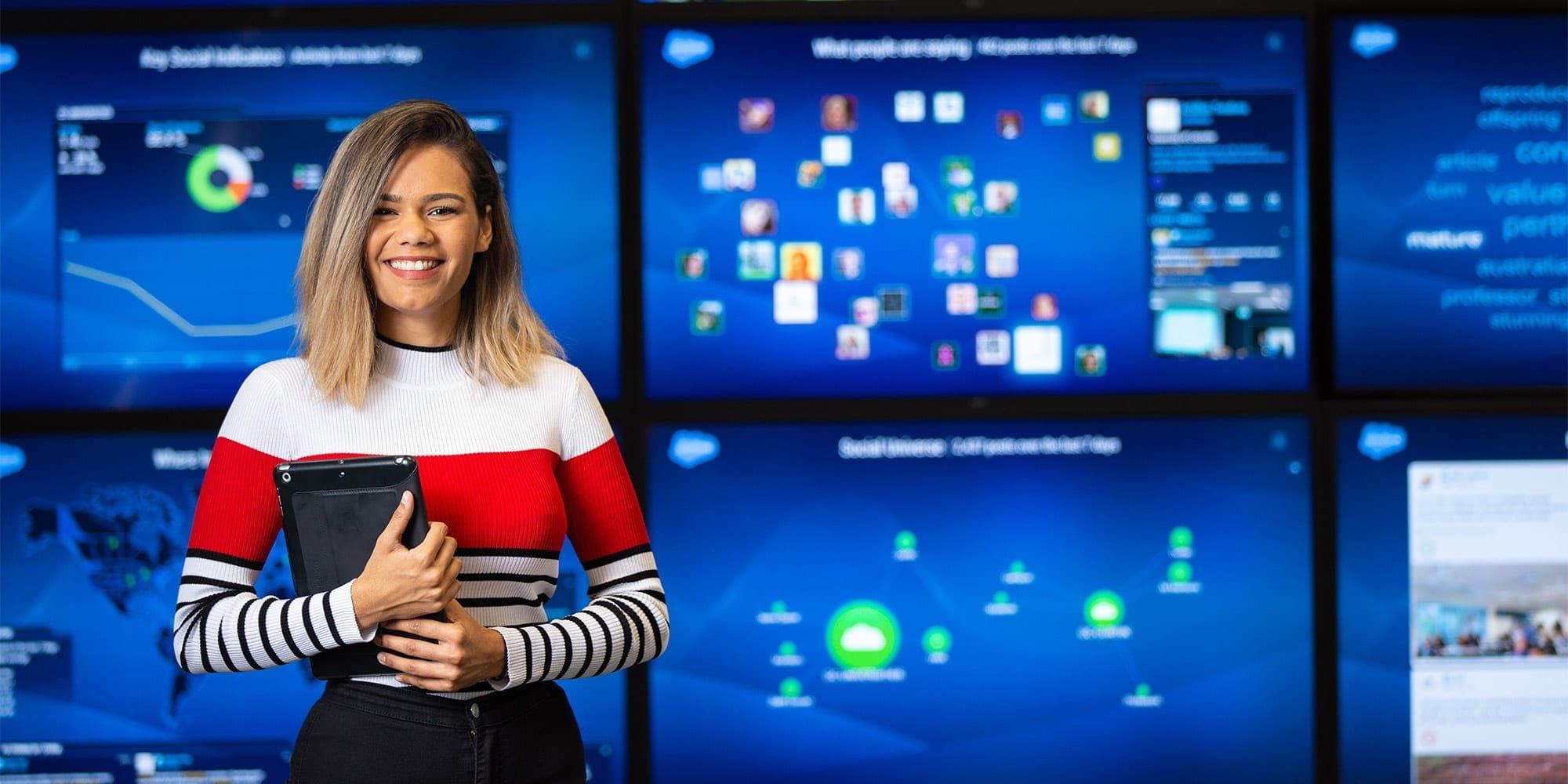 Woman standing in front of screen showing social media insights