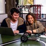 Two engineering students with a electronic car