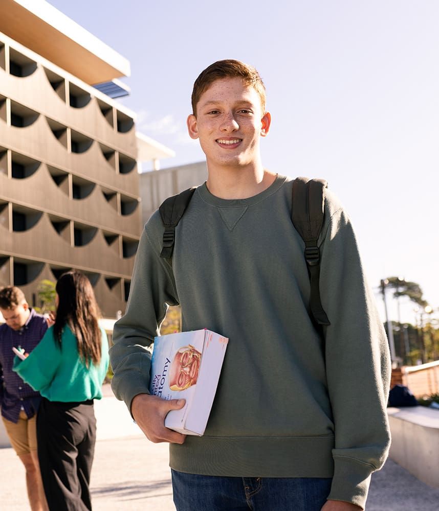 Young student in front of building