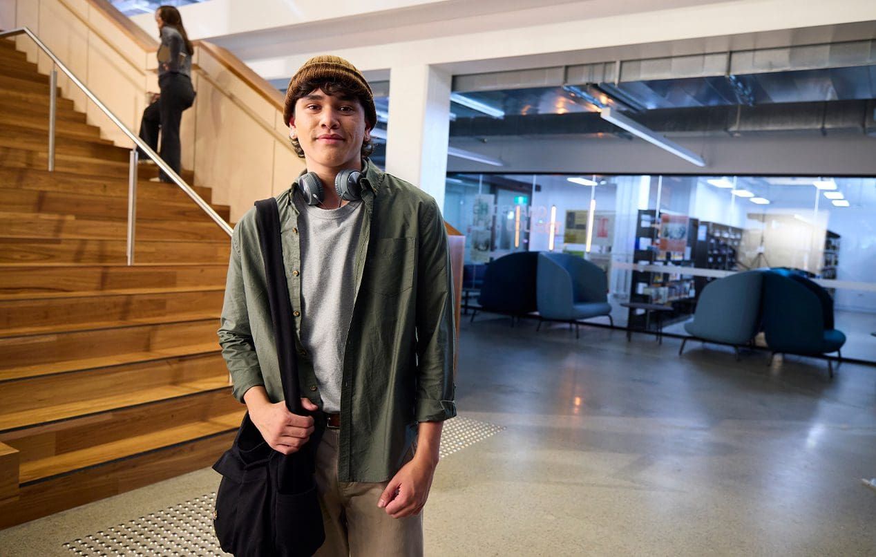 Student with backpack standing in library