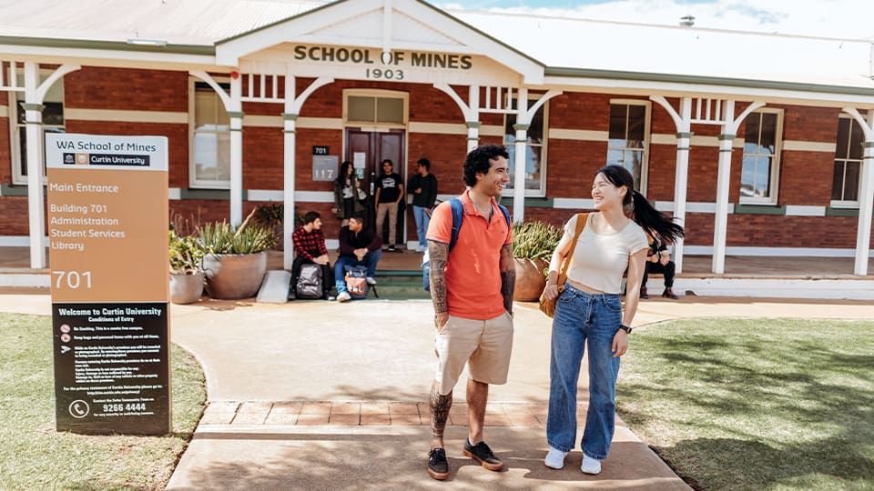 Male and female student standing outside Curtin Kalgoorlie campus