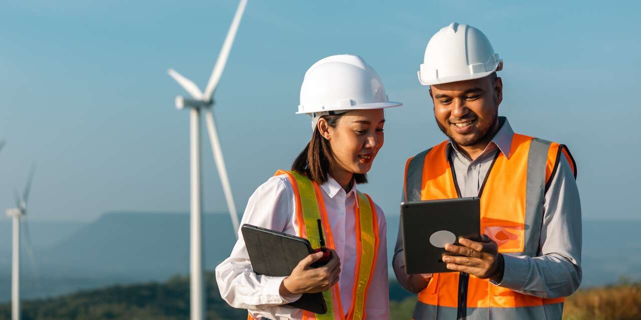 Two workers looking at an ipad