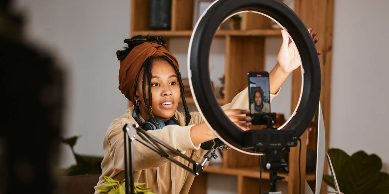 Female student adjusts a video setup