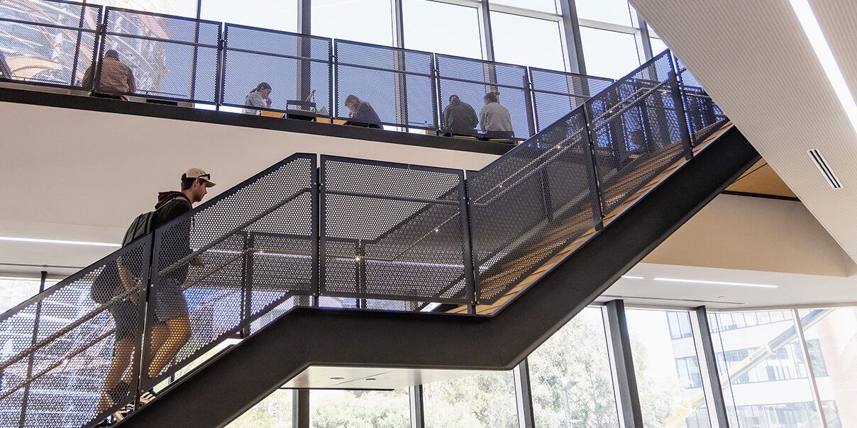 Two people walking up stairs