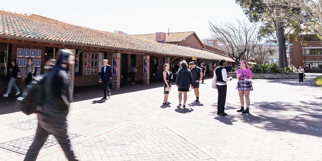 Student walking around campus blurred by motion