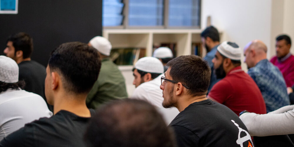 A group of Muslim men listening to a talk